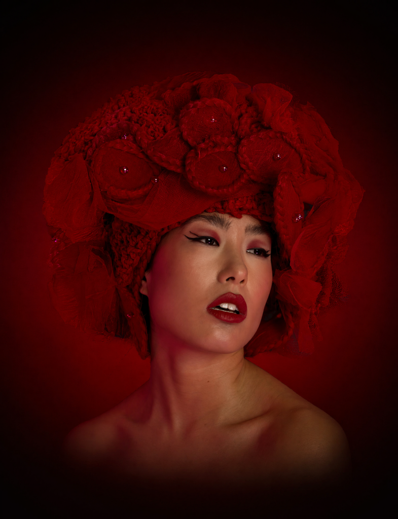 Commercial hair & makeup artist Sydney: editorial portrait with a sculptural red rose headpiece and matching red lip