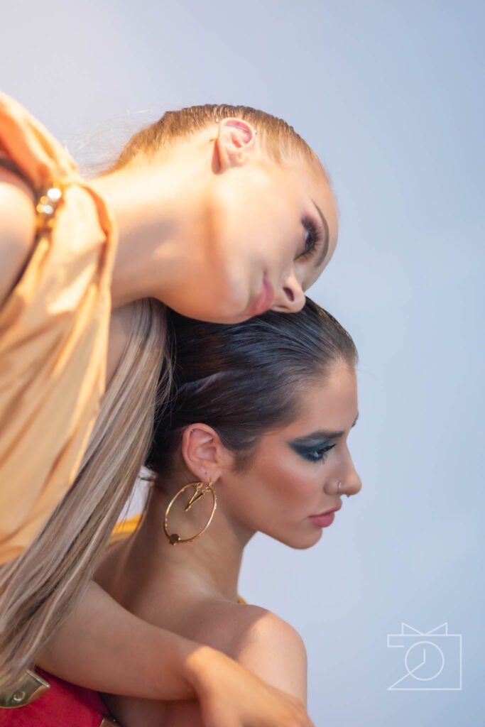 Hair & makeup artist Sydney: two models with gold-toned editorial eye makeup and sculpted brows, shot in profile