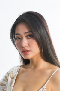 Natural glam makeup portfolio: close-up portrait of a woman with straight dark hair and natural glam makeup in a lace top